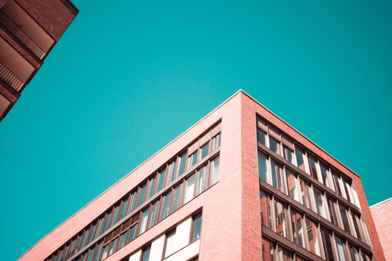 low-angle photography of red concrete building