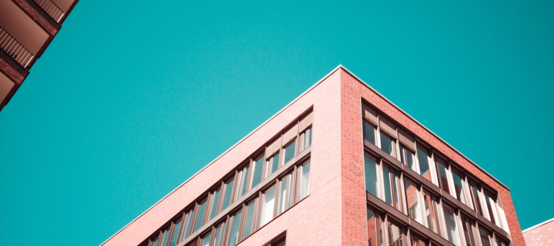 low-angle photography of red concrete building